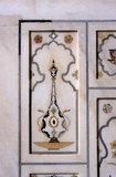 Pietra dura or pietre dure (see below), called parchin kari in South Asia, is a term for the inlay technique of using cut and fitted, highly-polished colored stones to create images.<br/><br/>Etimad-ud-Daula's Tomb (Urdu: اعتماد الدولہ کا مقبرہ‎, I'timād-ud-Daulah kā Maqbara) is a Mughal mausoleum in the city of Agra in the Indian state of Uttar Pradesh.<br/><br/>Along with the main building, the structure consists of numerous outbuildings and gardens. The tomb, built between 1622 and 1628 represents a transition between the first phase of monumental Mughal architecture - primarily built from red sandstone with marble decorations, as in Humayun's Tomb in Delhi and Akbar's tomb in Sikandra - to its second phase, based on white marble and pietra dura inlay, most elegantly realized in the Tāj Mahal.<br/><br/>The mausoleum was commissioned by Nūr Jahān, the wife of Mughal emperor Jahangir, for her father Mirzā Ghiyās Beg, originally a Persian Amir in exile, who had been given the title of I'timād-ud-Daulah (Pillar of the State). Mirzā Ghiyās Beg was also the grandfather of Mumtāz Mahāl (originally named Arjūmand Bāno, daughter of Asaf Khān), the wife of the emperor Shāh Jahān, responsible for the construction of the Tāj Mahal.