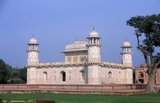 Etimad-ud-Daula's Tomb (Urdu: اعتماد الدولہ کا مقبرہ‎, I'timād-ud-Daulah kā Maqbara) is a Mughal mausoleum in the city of Agra in the Indian state of Uttar Pradesh.<br/><br/>Along with the main building, the structure consists of numerous outbuildings and gardens. The tomb, built between 1622 and 1628 represents a transition between the first phase of monumental Mughal architecture - primarily built from red sandstone with marble decorations, as in Humayun's Tomb in Delhi and Akbar's tomb in Sikandra - to its second phase, based on white marble and pietra dura inlay, most elegantly realized in the Tāj Mahal.<br/><br/>The mausoleum was commissioned by Nūr Jahān, the wife of Mughal emperor Jahangir, for her father Mirzā Ghiyās Beg, originally a Persian Amir in exile, who had been given the title of I'timād-ud-Daulah (Pillar of the State). Mirzā Ghiyās Beg was also the grandfather of Mumtāz Mahāl (originally named Arjūmand Bāno, daughter of Asaf Khān), the wife of the emperor Shāh Jahān, responsible for the construction of the Tāj Mahal.
